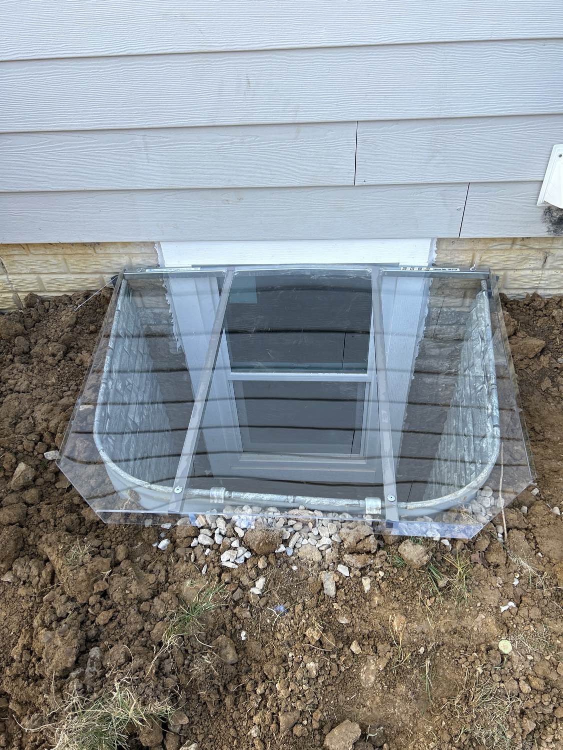 Completed egress window project — crew on site